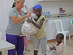 A young mother learning at our Malnutrition Center in Haiti