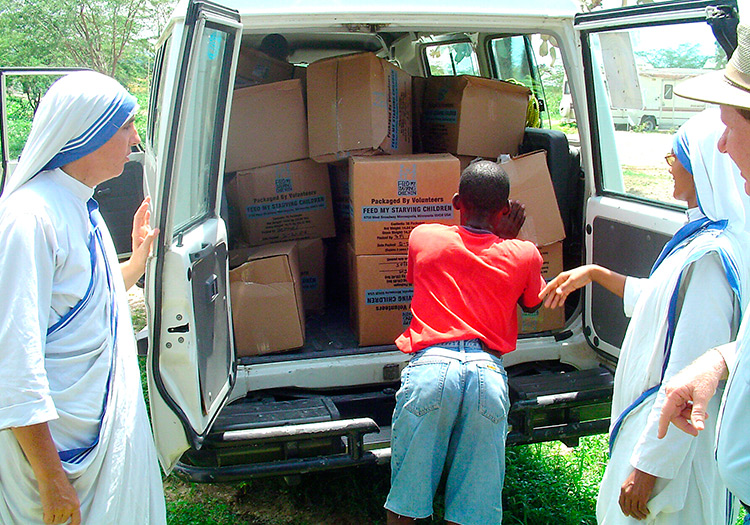 Missionazry nuns receiving food for their orphanage.