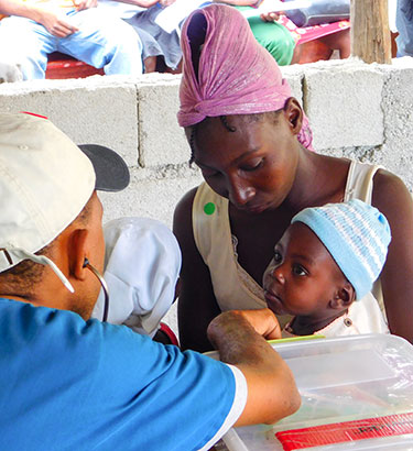 Young mother and child at the Mobile Medical Clinic in Lastik..