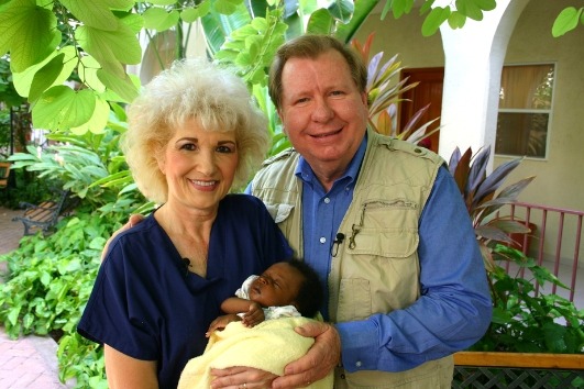 Bobby and Sherry Burnette lovingly embrace a new baby brought into the Love A Child Children's Home family