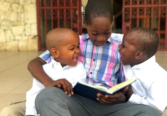 Pictured here are Samuel, Job, and Noah during their Bible reading time. Love A Child continues by faith to raise the standard of care in meeting the needs of the children we serve.
