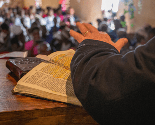 Bobby Burnette's hand on Bible from the Church pulpit in Fond Parisien, Haiti
